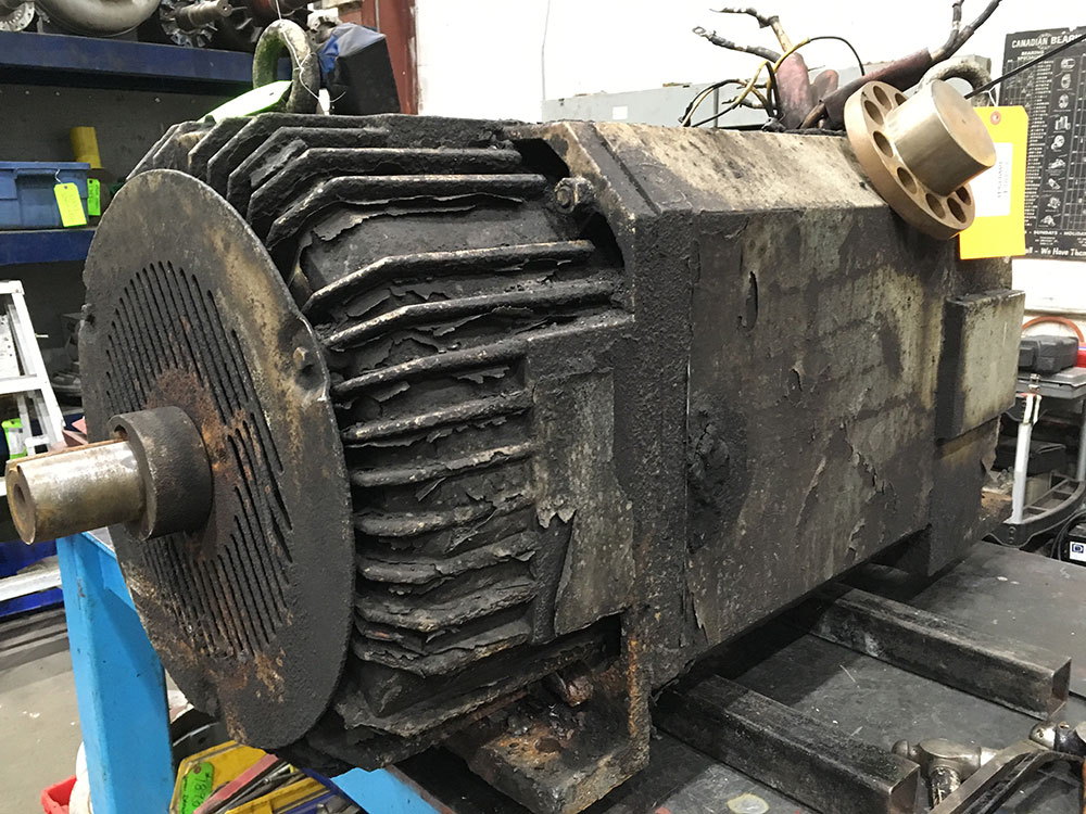 Dirty industrial DC motor in Duke Electric repair shop