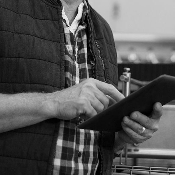 Smiling factory worker using digital tablet in the factory